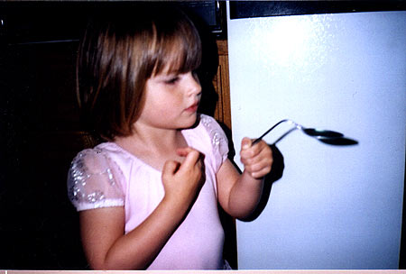 Olivia bends a spoon